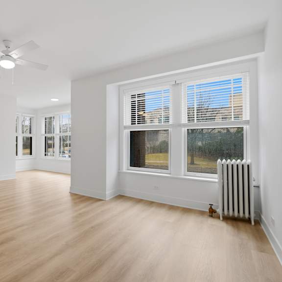 a room with a window and a fan.