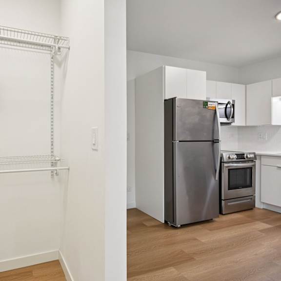 a kitchen with a refrigerator, oven, and microwave.