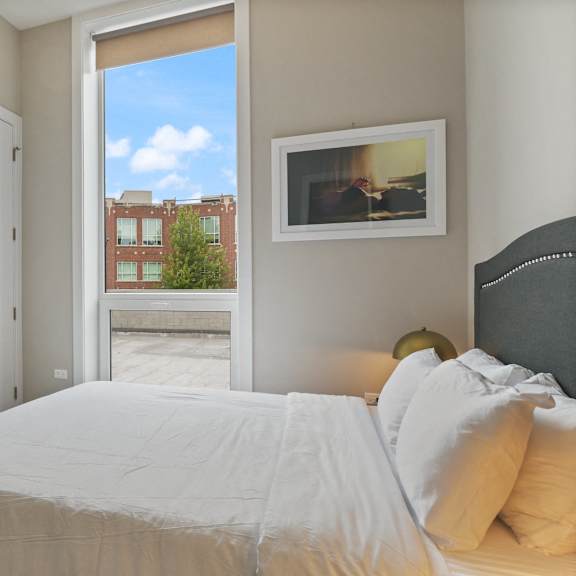 a bedroom with a large bed and a window