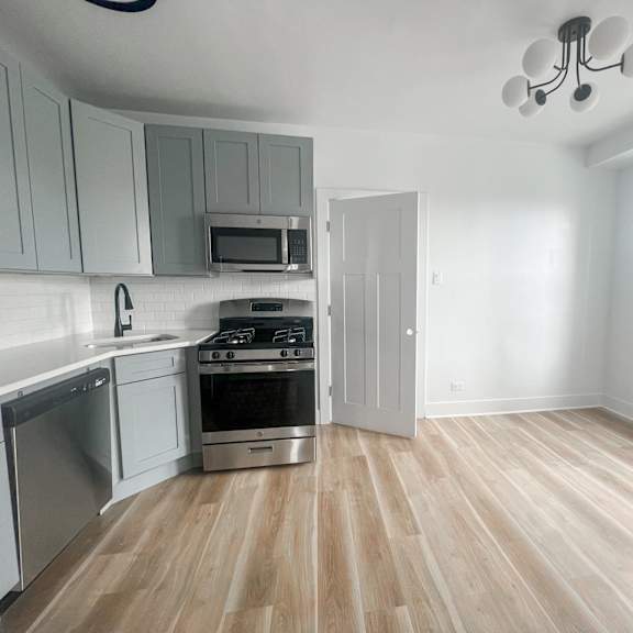 a kitchen with a stove top oven and a microwave above the stove.