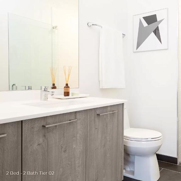 a white bathroom with a toilet and a sink