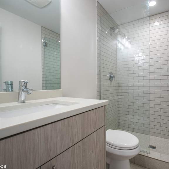 a bathroom with a white toilet and a sink.