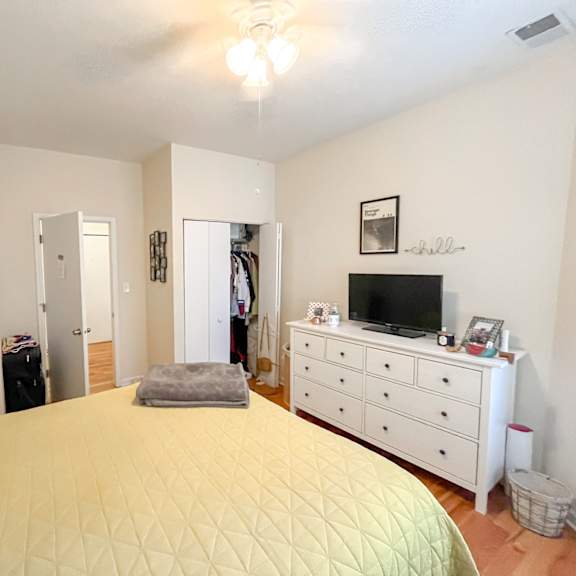 a bedroom with a large bed and a tv