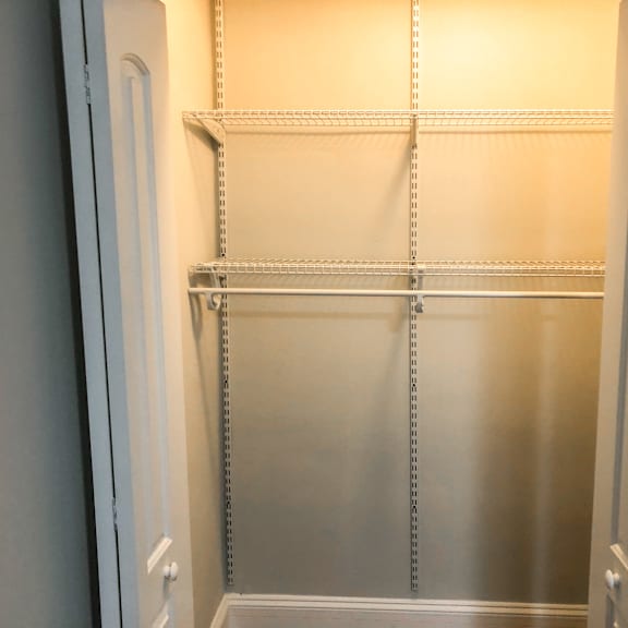 a white refrigerator with empty shelves and drawers.