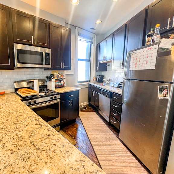 a kitchen with granite countertops and stainless steel appliances.