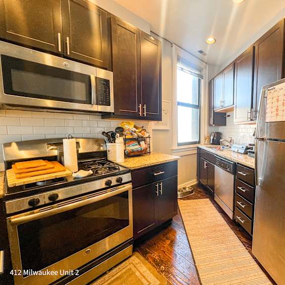 a kitchen with a stove, oven, and refrigerator.