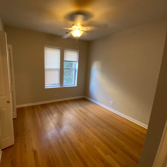 the interior of a house with wooden floors and a ceiling fan