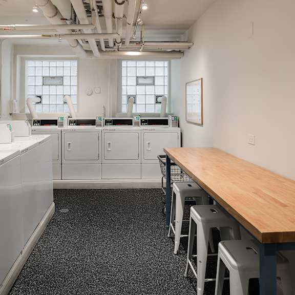 a laundry room with washers and dryers.