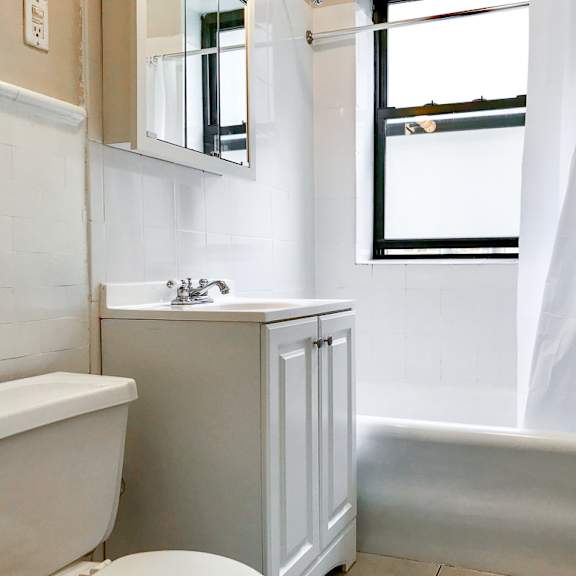 a small bathroom with a sink toilet and bath tub