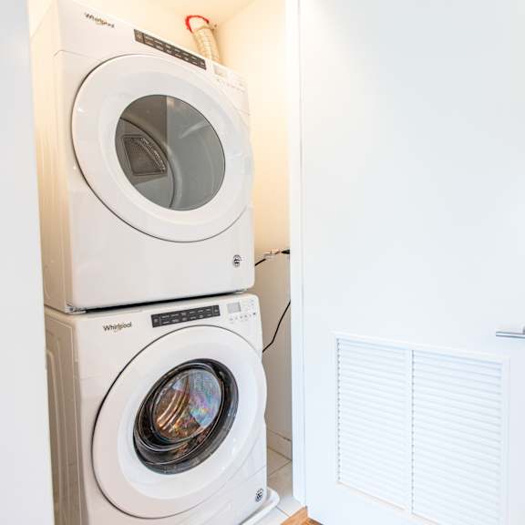 a washer and dryer in a laundry room with a white door