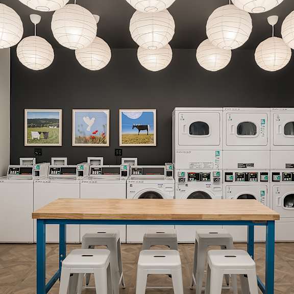 a laundry room with a table and stools