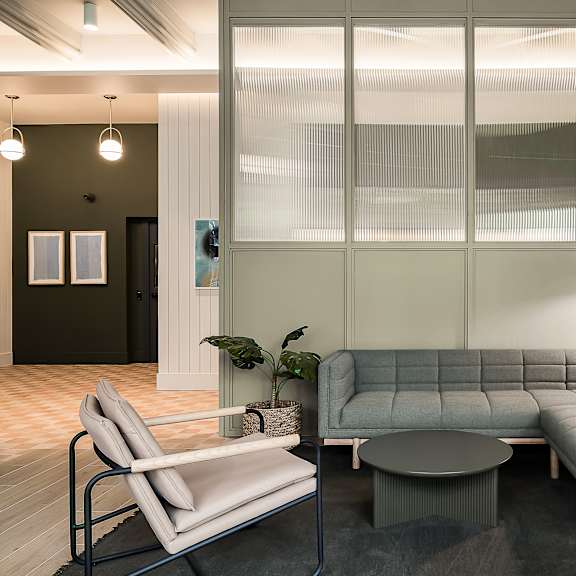 a living room with a gray couch and a table