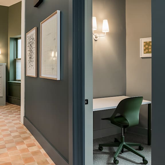 a room with a desk and a chair and a door