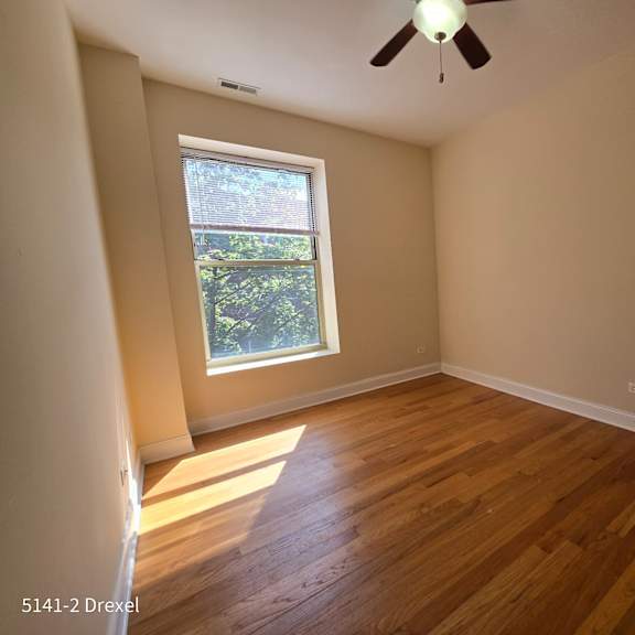 the living room of a house with wooden floors and a window