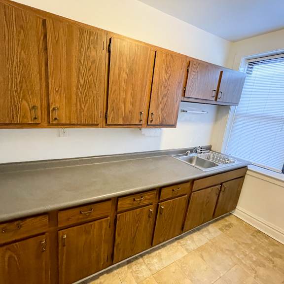 a kitchen with wooden cabinets and a countertop.