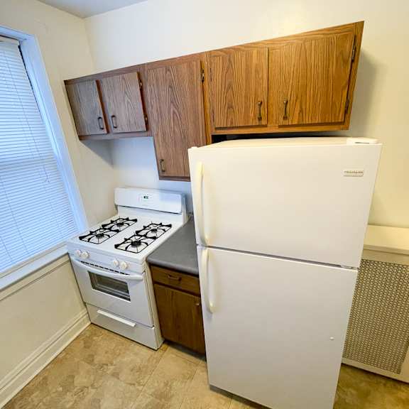 a kitchen with a white fridge and a white stove.