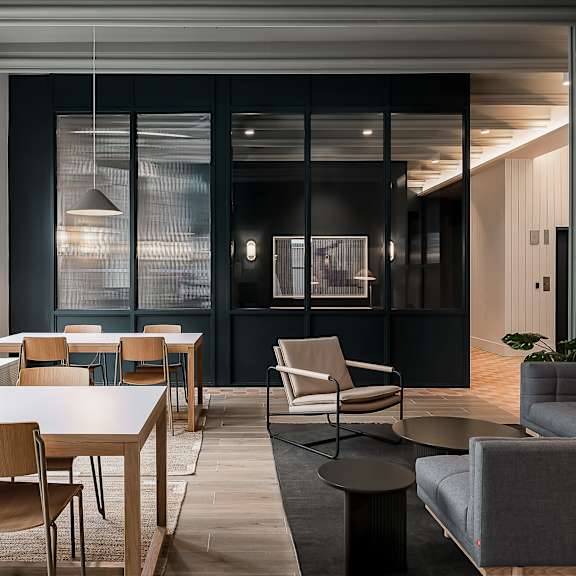 a modern dining room with a long table and chairs.