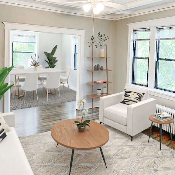 a living room with a white couch, a wooden coffee table, and a ceiling fan.