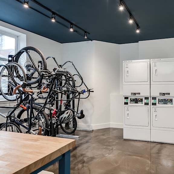 a kitchen with a bunch of bikes on the wall