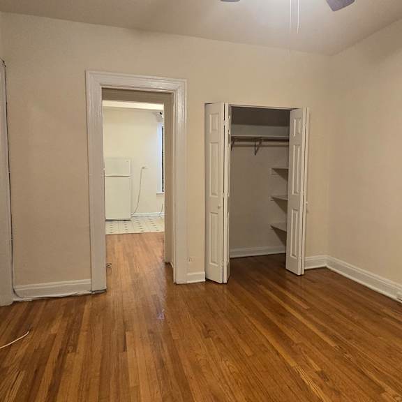 a room with wooden floors and white walls.