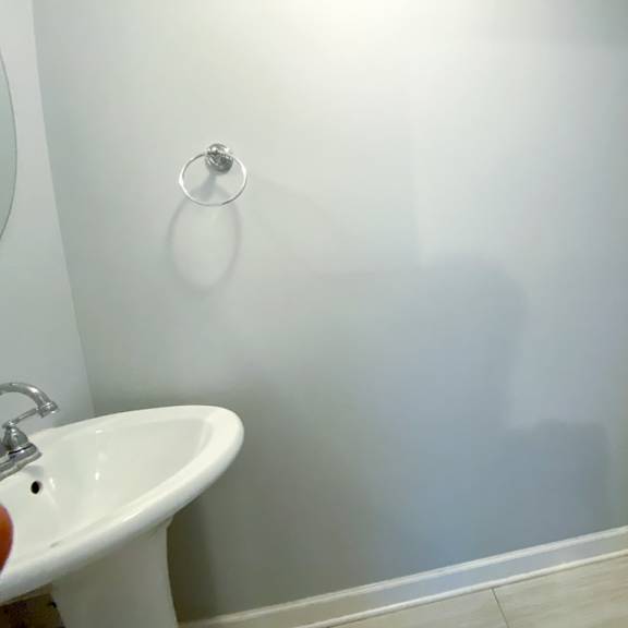 a white bathroom with a sink and a toilet