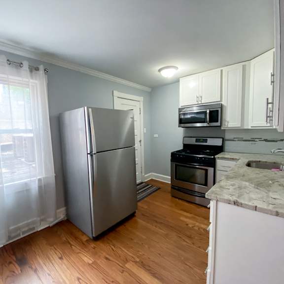a kitchen with stainless steel appliances and a window