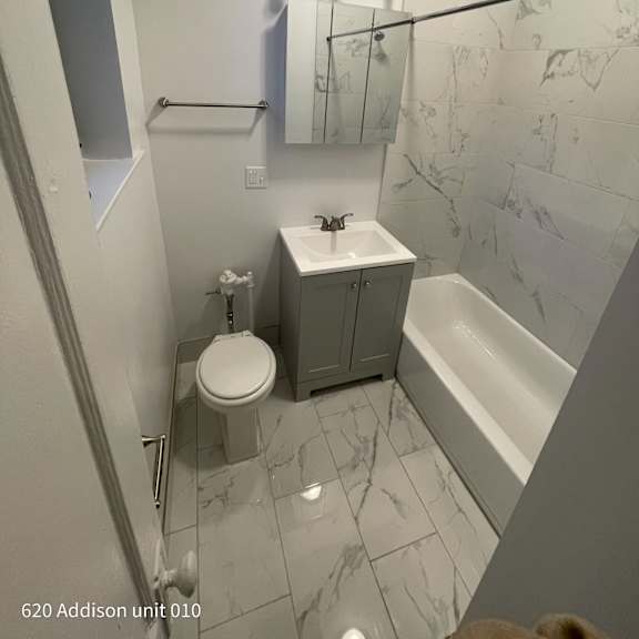 a small bathroom with a toilet sink and tub