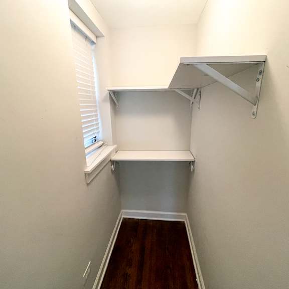 a white shelf is mounted on a white wall.