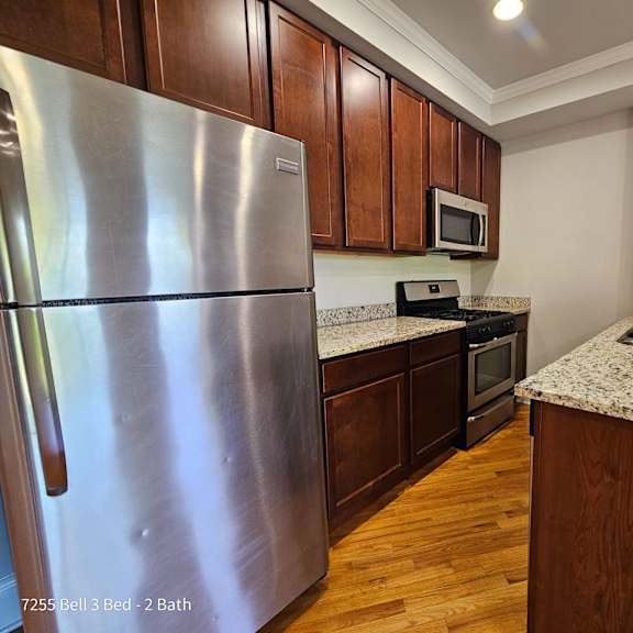 a kitchen with stainless steel appliances and granite counter tops