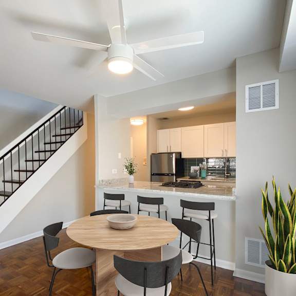 a modern kitchen with a dining table and chairs.