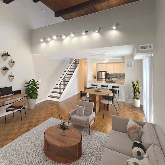 a living room with a couch, a coffee table, and a staircase.