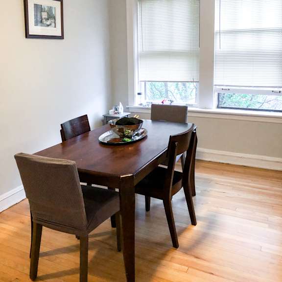 a dining room with a table and chairs and a ceiling fan