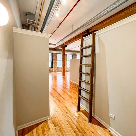 a wooden staircase in a room with white walls.