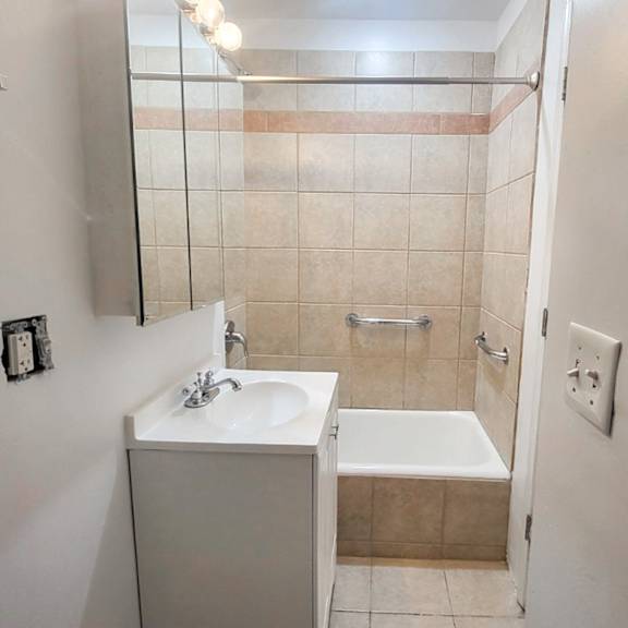 a bathroom with a white sink and a white bathtub.