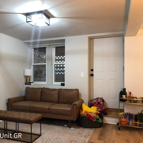 a living room with a brown couch and a coffee table.
