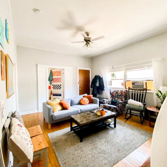 a living room with a couch, chairs, and a coffee table.