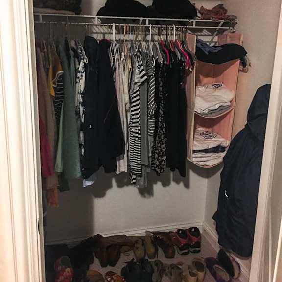 a closet full of clothes and shoes.