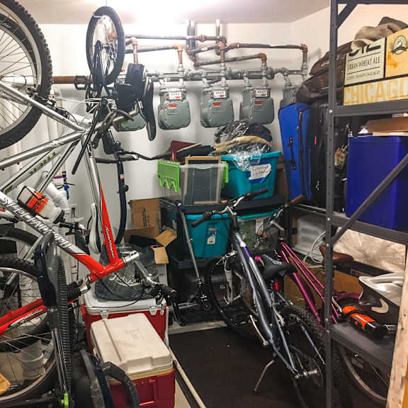 a bike repair shop with a bicycle hanging from the ceiling.