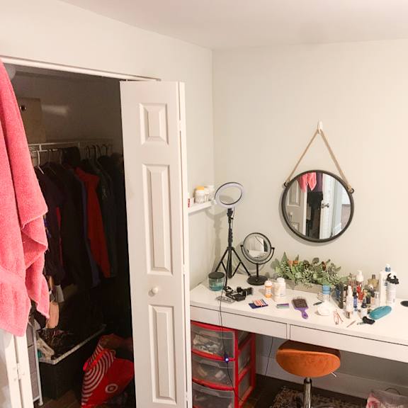 a room with a vanity table and a mirror.
