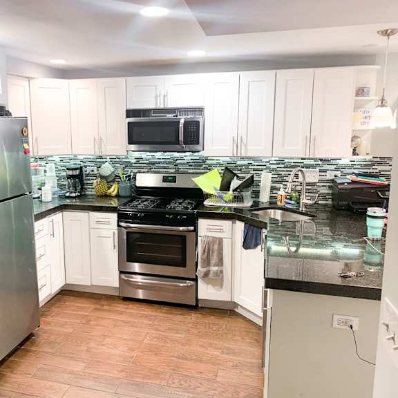 a kitchen with a refrigerator, oven, and microwave.
