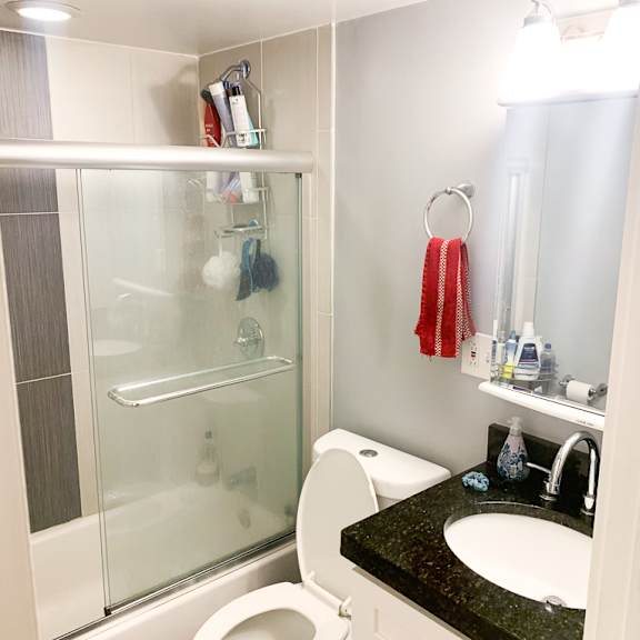 a white toilet sits in a bathroom next to a sink.