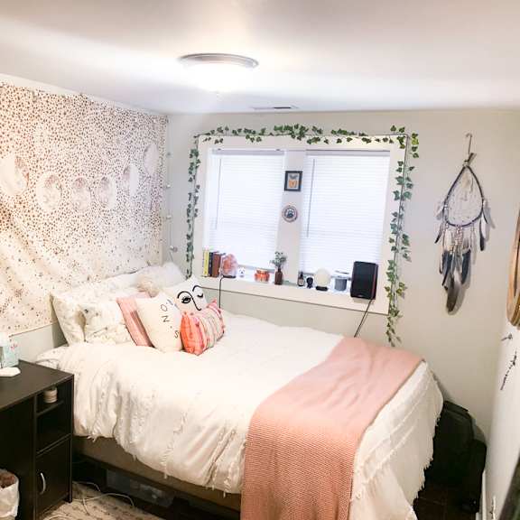 a bedroom with a bed, desk, and chair.