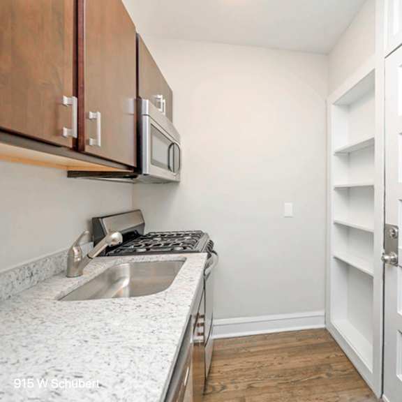 a kitchen with a sink and a white door