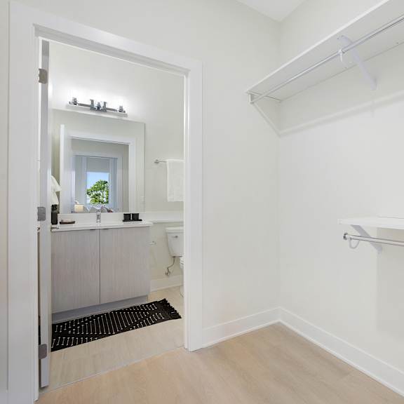 a white bathroom with a walk-in shower and a toilet.
