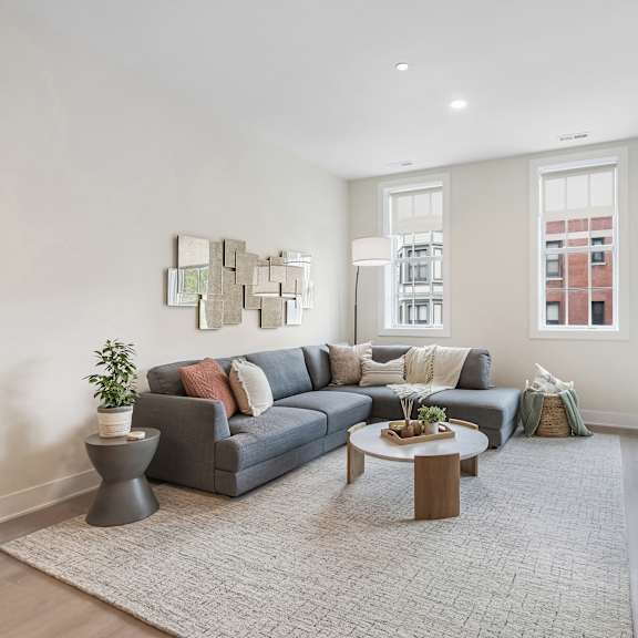 a living room with a grey couch and a coffee table.