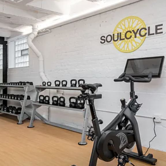 a gym with soulcycle branding on the wall.