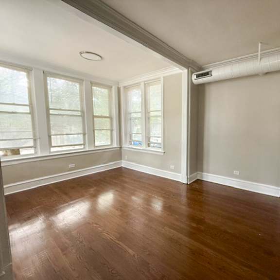 a room with wood floors and white walls.