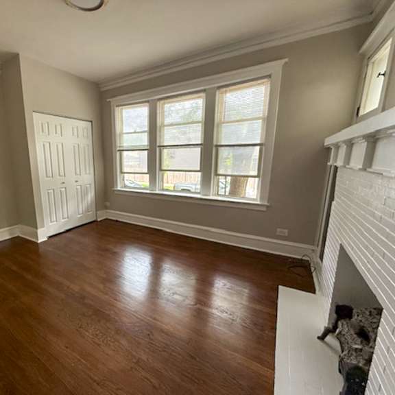 a room with wooden floors and a fireplace.