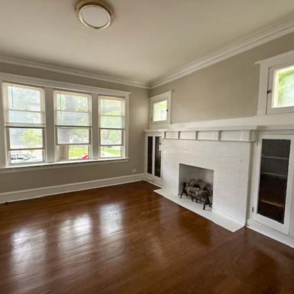 a room with a fireplace and a window.