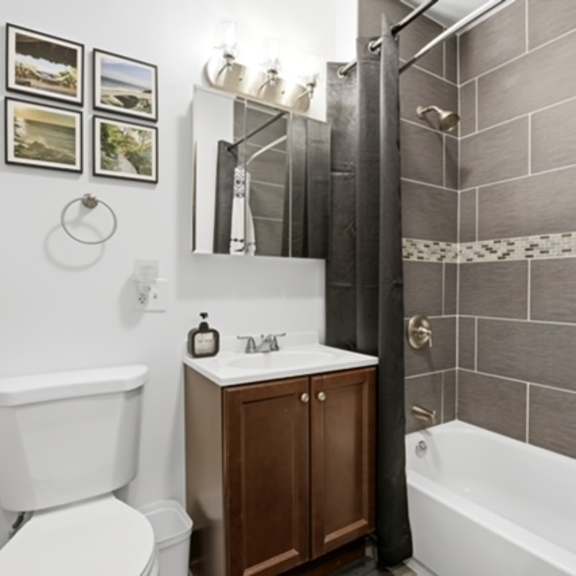 a bathroom with a white toilet, a white sink, and a white bathtub.